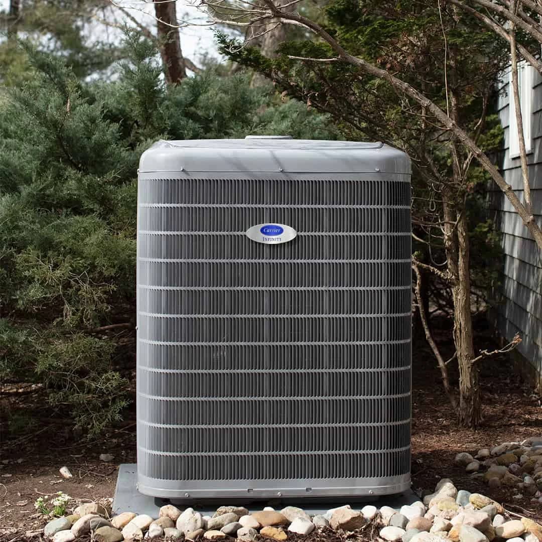 Outdoor Carrier cooling unit installed in a landscaped rock area